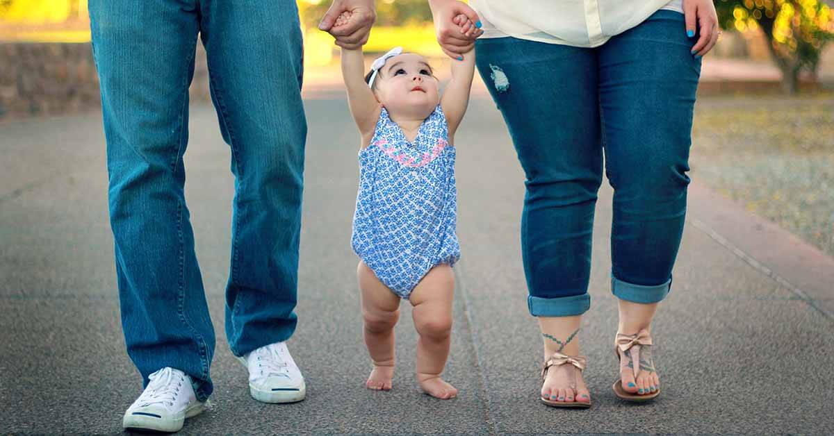 A family of three walking in the outdoors