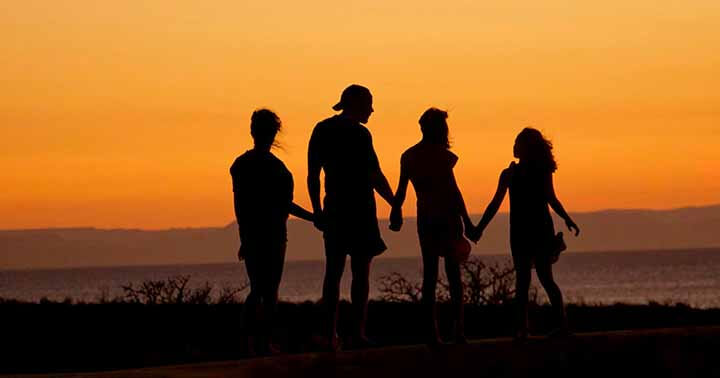 A family of four during sunset