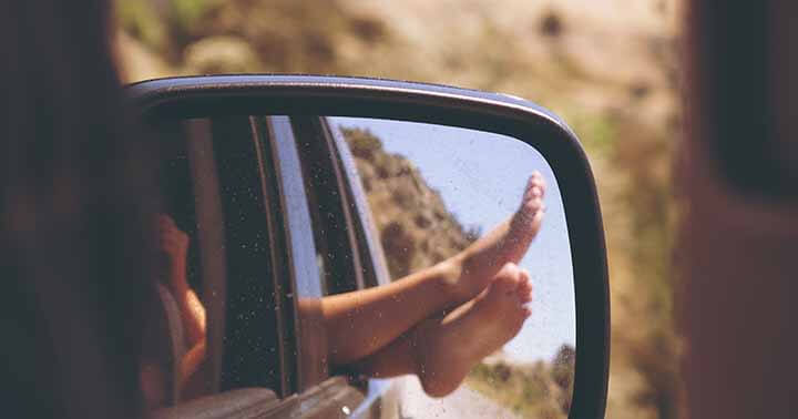 Happy feet dangling out of the car window