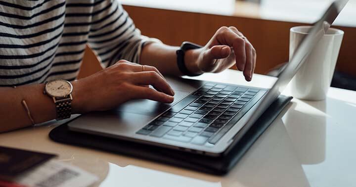 A person typing on a laptop