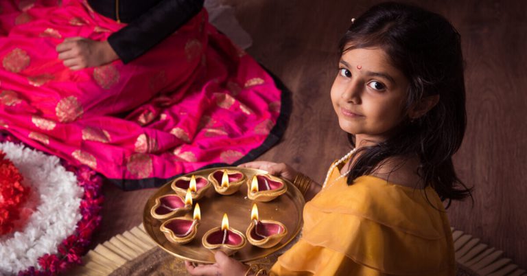 A girl with rangoli during Deepavali