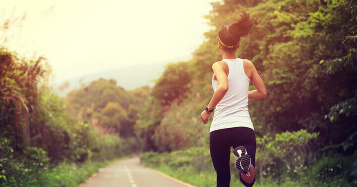 A lady jogs along a quiet road