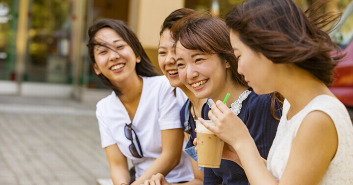 A group of young ladies drinking and chatting happily