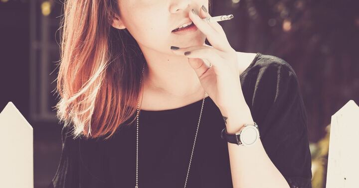 A lady smoking outdoor