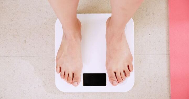 A person standing on a weighing scale