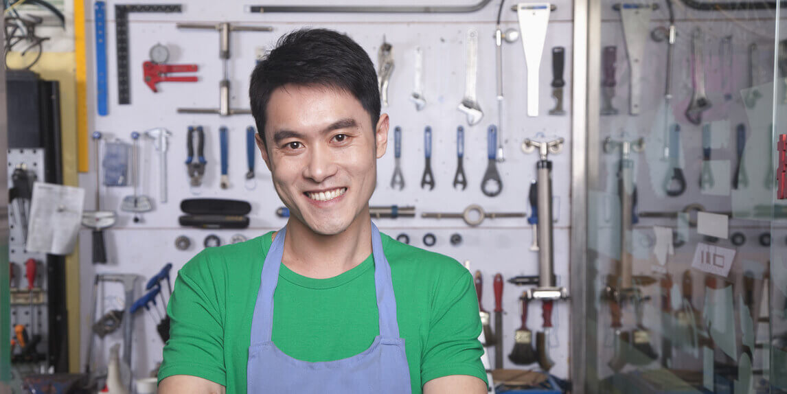 Confident looking man in front of various tools for DIY at home