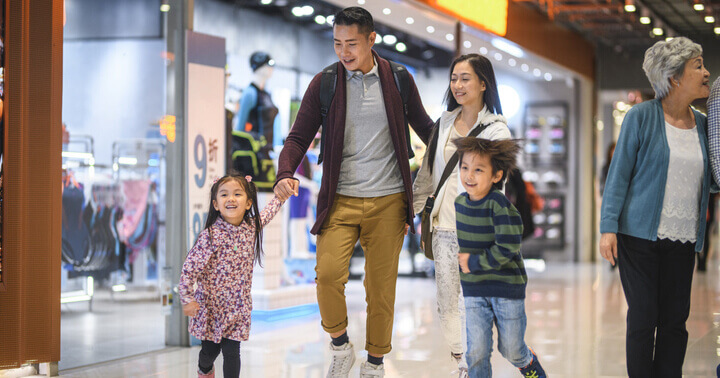 Parents and children walking together in a shopping mall
