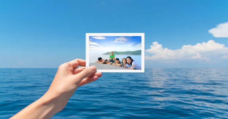 A picture of a family on travel against a seascape