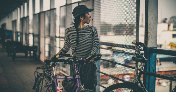 A lady walking with her bicycle