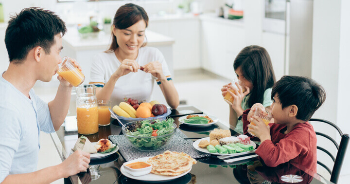 A family eating a healthy and balanced meal full of fruits and vegetables