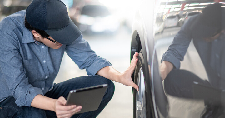 A mechanic inspecting a car tire