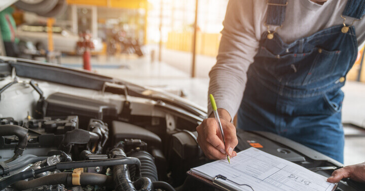 A mechanic checking the car engine