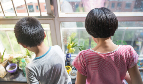 Children looking at indoor plants at home