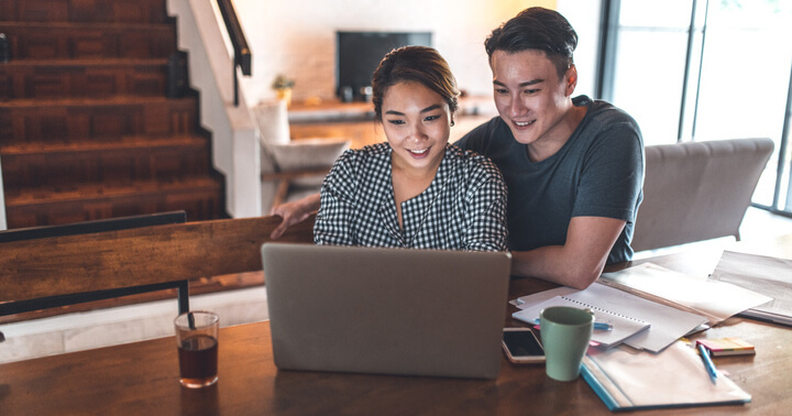 A couple deciding on online insurance savings plan as part of their money management effort