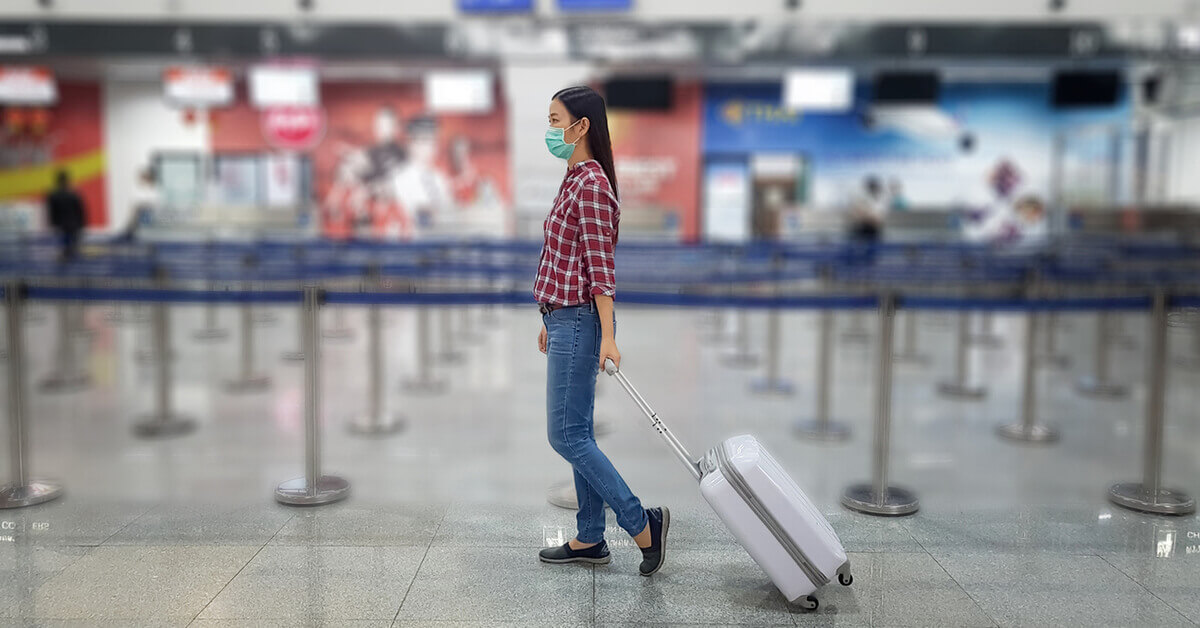 Girl pulling luggage at airport