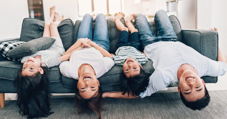 Happy, relaxed family of four on the couch