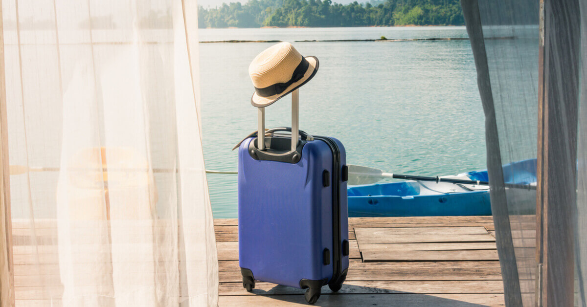 A luggage bag left by the dock overlooking the river