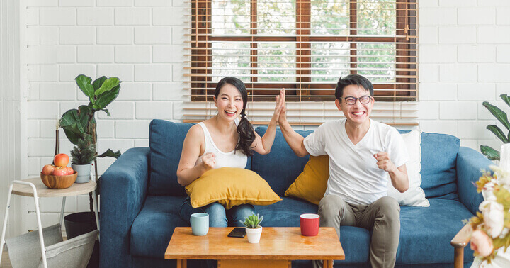 A happy couple looking excited at the prospects of great insurance savings returns