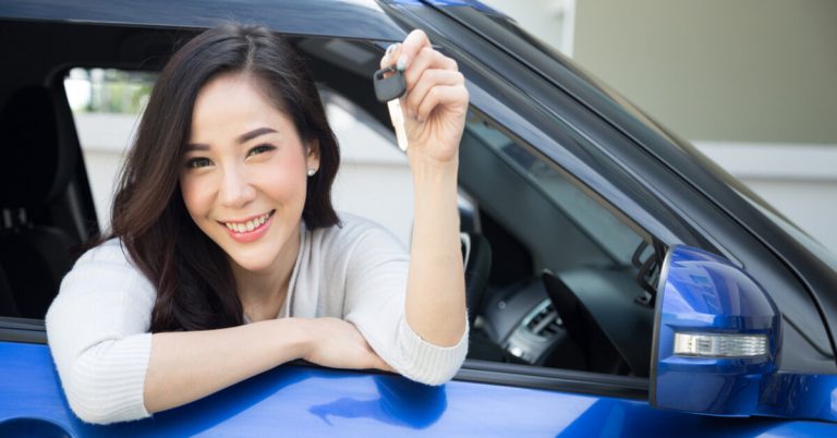 Happy lady looking out of car window