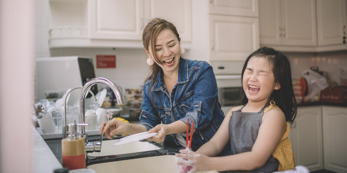 Mother and daughter having fun using life hacks in the kitchen