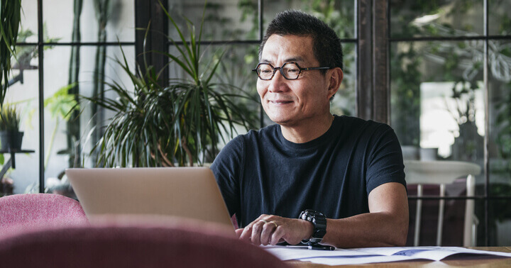 A man working from home on his laptop while social distancing