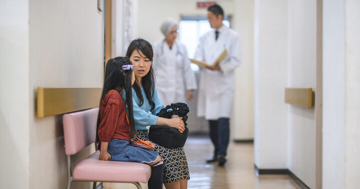 A mother and daughter waiting for their turn at the hospital