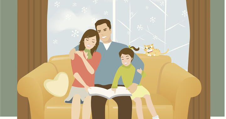 Family of three snuggling in a couch with their pet cat at home
