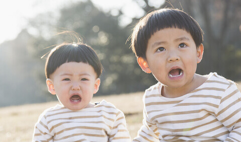 Two toddlers looking surprised