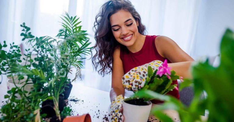 A lady watering her plants at home