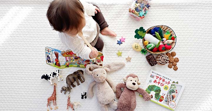 Toddler with various toys