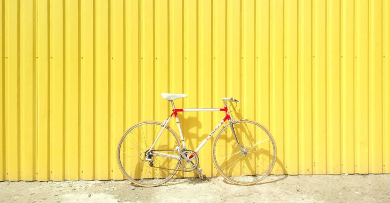Cycling in Singapore, bicycle against yellow wall