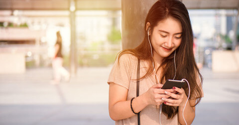 Young lady smiling into phone