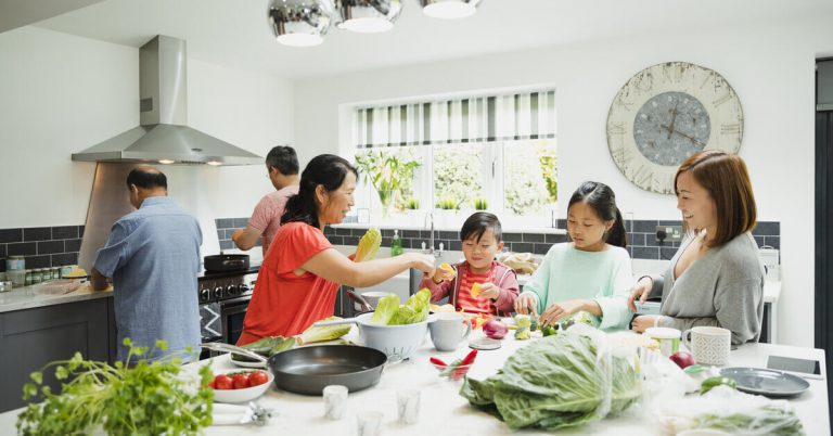 A family with domestic helper preparing a meal