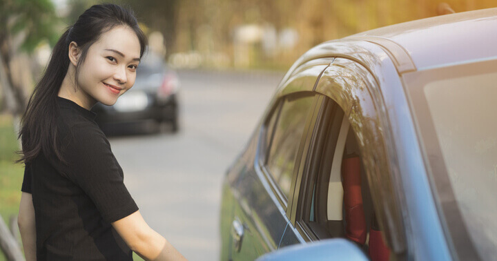 A woman ready to enter and drive her car