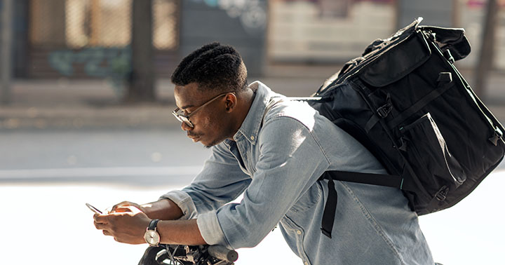 Young African delivery men checking delivery address before delivering package.