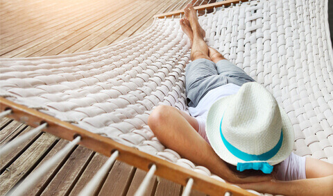 A lady relaxing on a wooden deck 