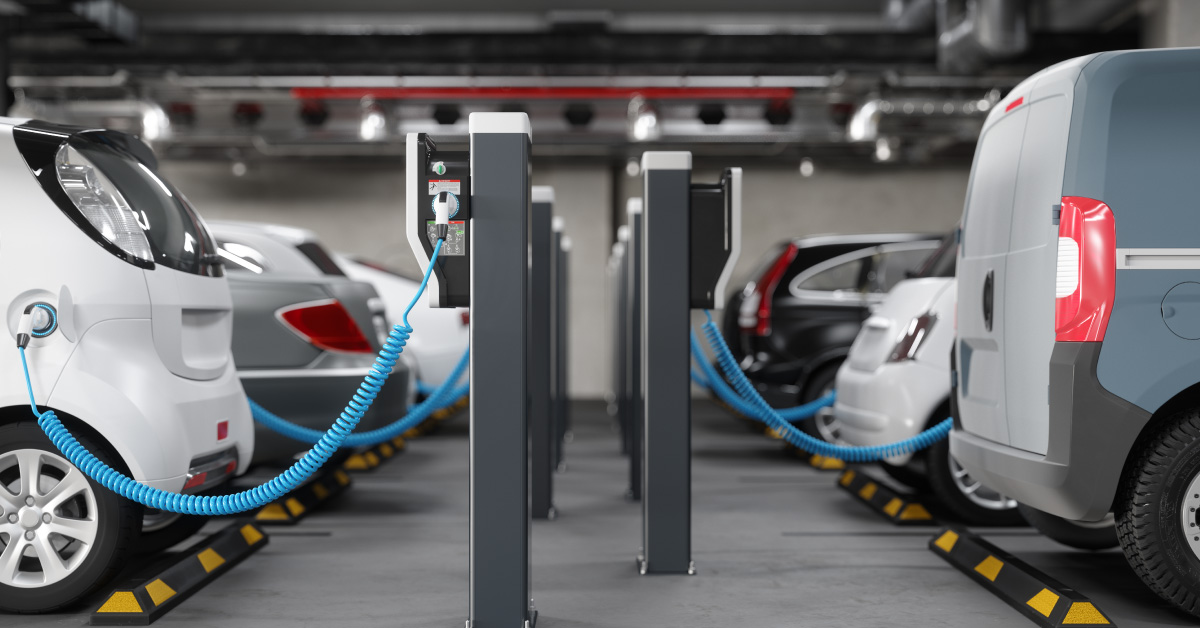 side-view-of-charging-electric-cars-in-parking-garage-clean-energy-concept