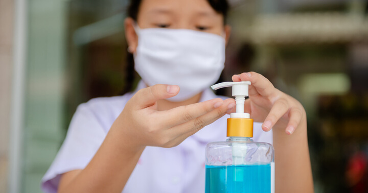 A school student about to wash her hands with soap and water