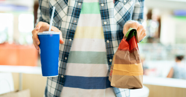 A man holding takeaway fastfood meal