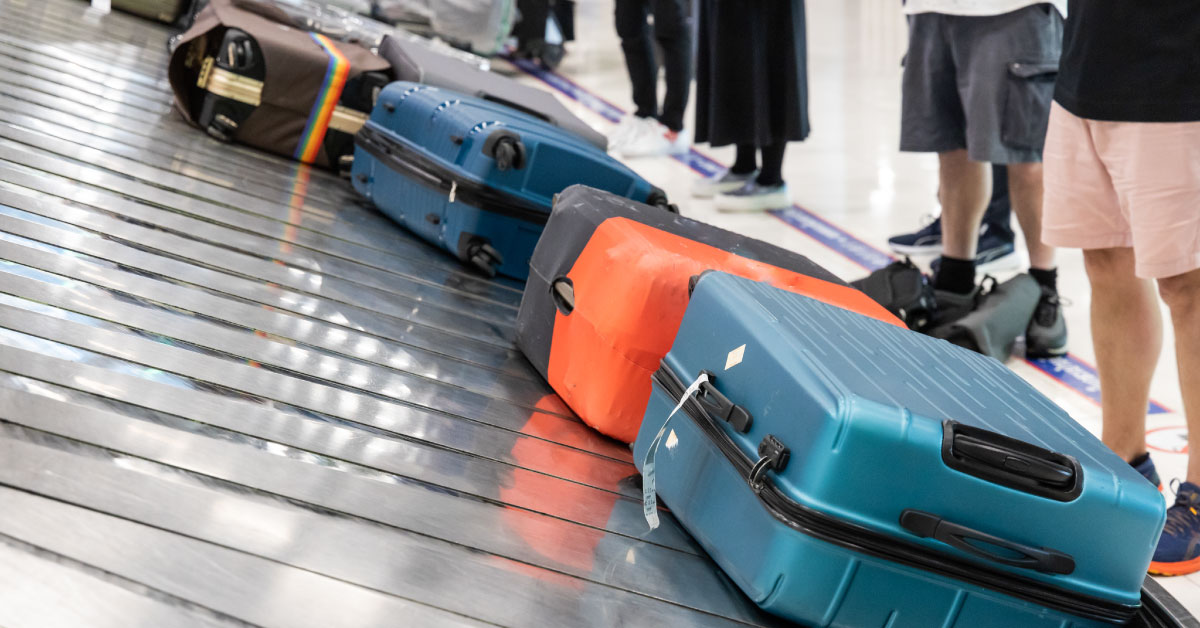 baggage-luggage-at-airport-arrival-carousel-with-passengers-awaiting-to-claim-theirs