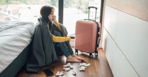 travel-illness-a-woman-resting-on-the-floor-while-feeling-unwell