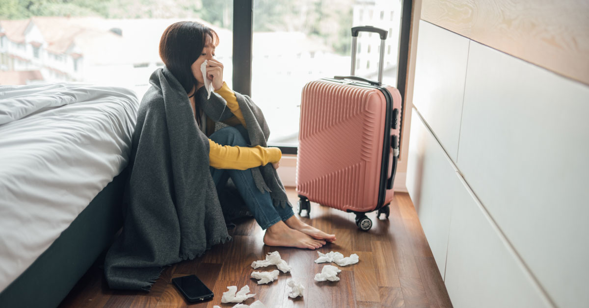 travel-illness-a-woman-resting-on-the-floor-while-feeling-unwell