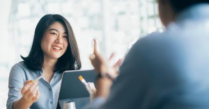 A smiling lady trying to understand life insurance review