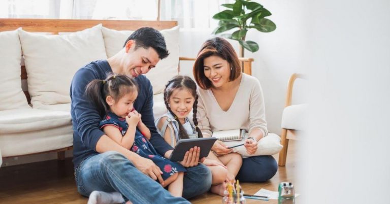 A family looking into an ipad for life insurance review