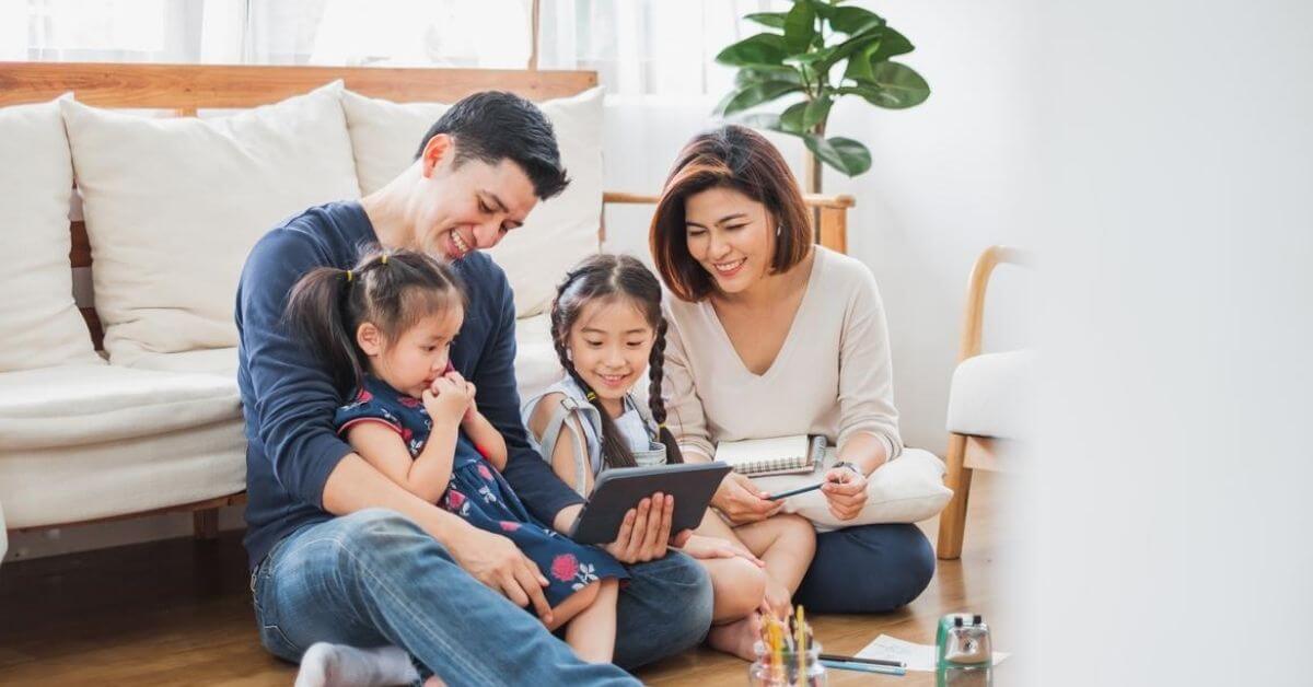 A family looking into an ipad for life insurance review