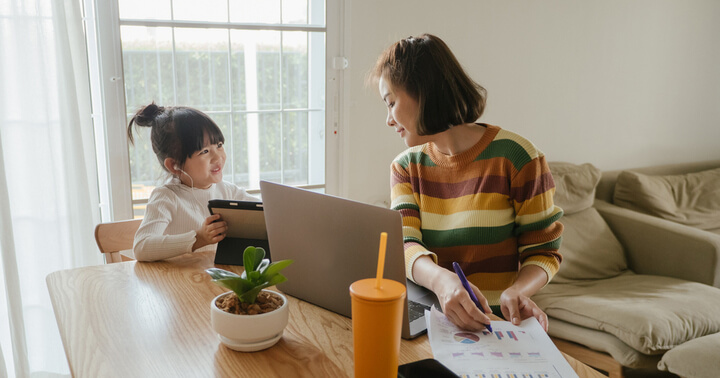 A daughter accompanying her mother while she is working from home