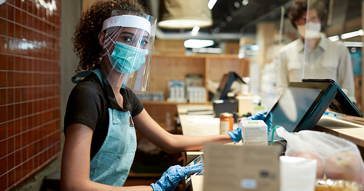 Service staff wearing surgical mask and face shield