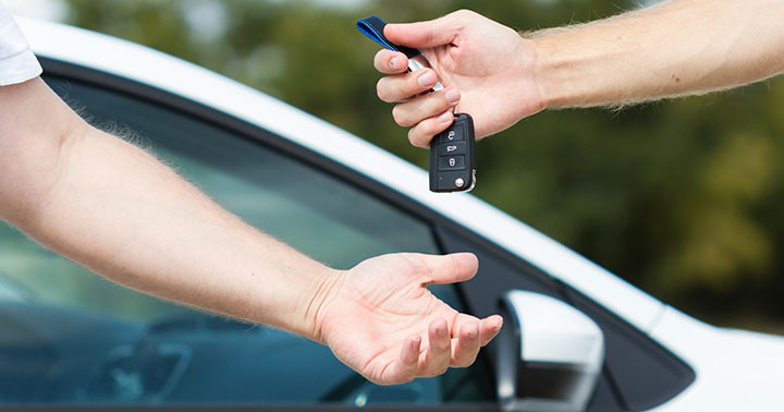 Handing over the car keys after a successful sale