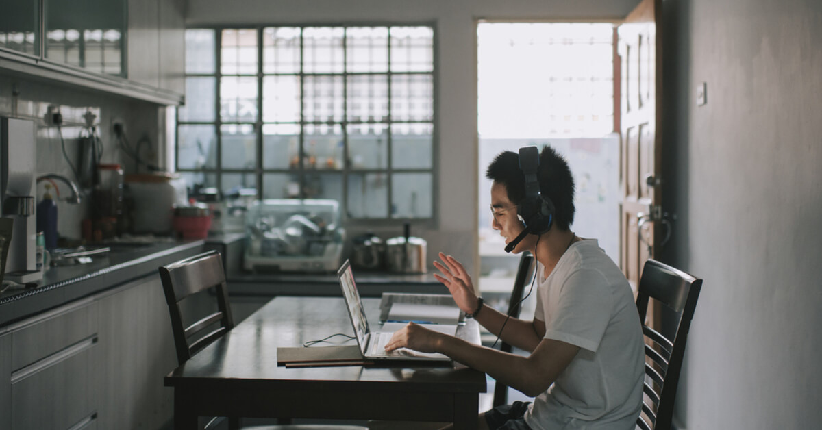 Young man attending online courses at home