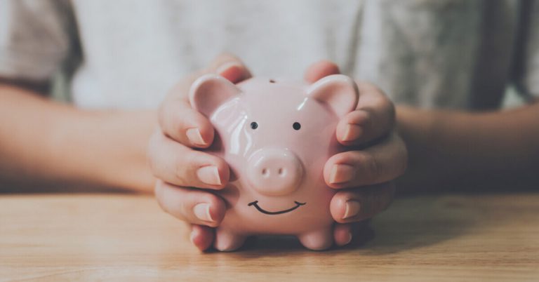 A pair of hands holding piggy bank thinking of how to maximise savings
